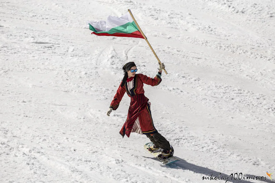 PAMPOROVO, BULGARIA - MARCH 03, 2017 - Skiing with Bulgarian flags at Pamporovo, Bulgaria. People dressed with traditional bulgarian clothes skiing with the national flag.