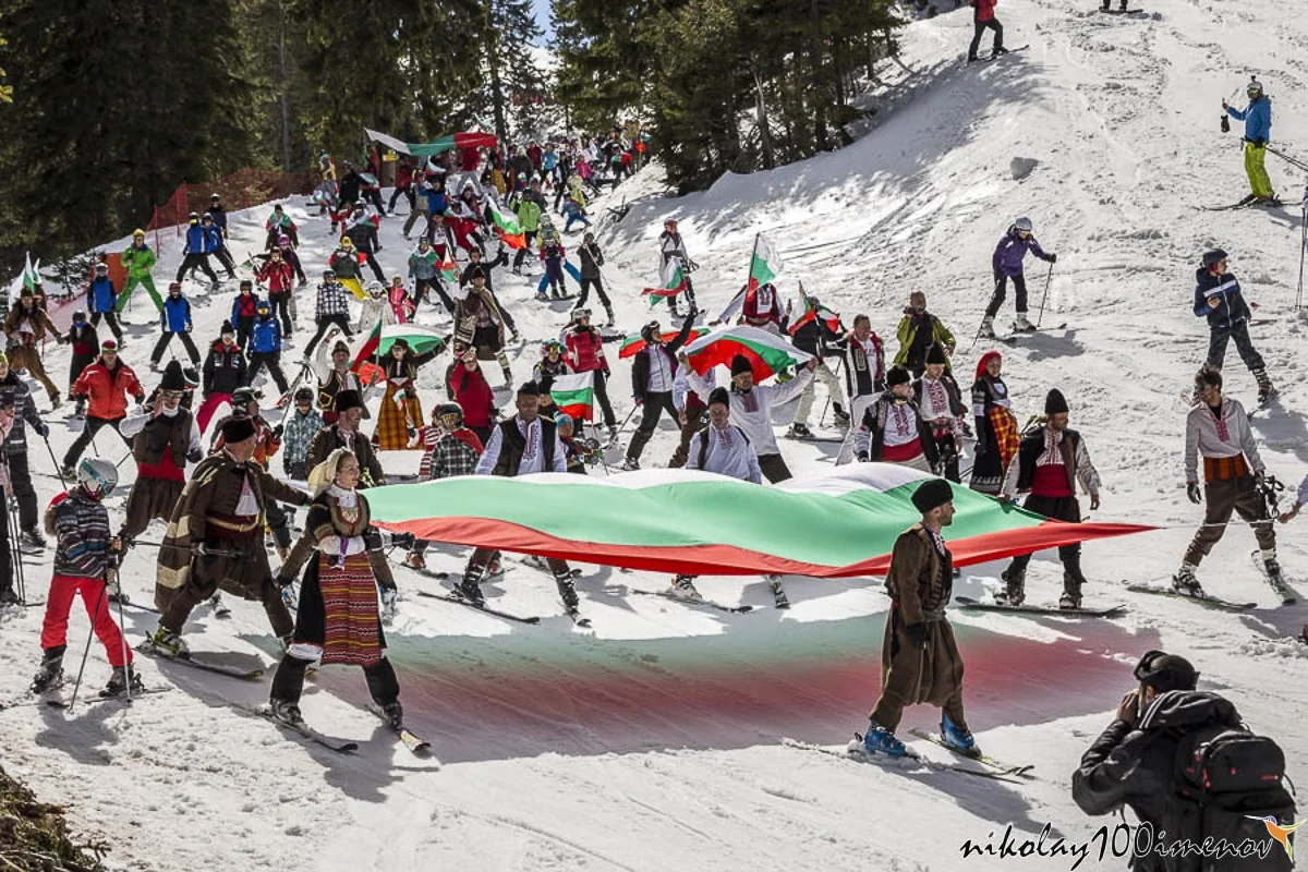 PAMPOROVO, BULGARIA - MARCH 03, 2017 - Skiing with Bulgarian flags at Pamporovo, Bulgaria. People dressed with traditional bulgarian clothes skiing with the national flag.