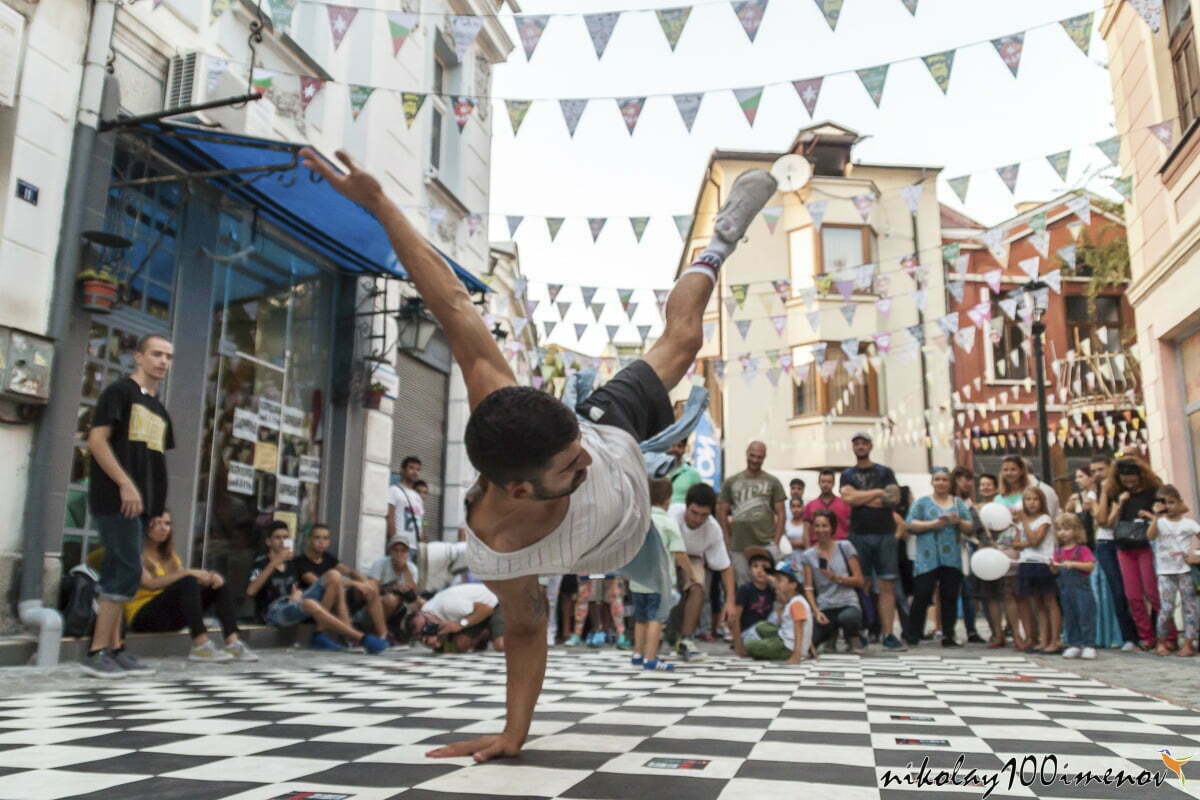 PLOVDIV, BULGARIA - SEPTEMBER 19, 2015 - Kapana street festival in Plovdiv, Bulgaria. Teenagers preform break-dancing in front of the crowd on the street.