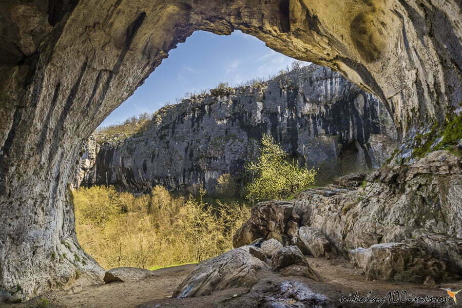 Prohodna cave also known as God's eyes near Karlukovo village, Bulgaria. Colorful cave with giant entrance.